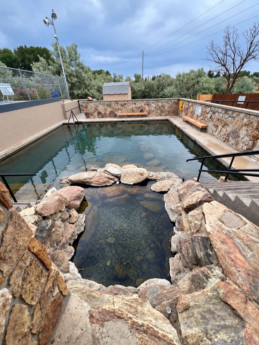 The rock-lined Lobster Pot soaking pool beside the main pool at the Hobo Hot Pool